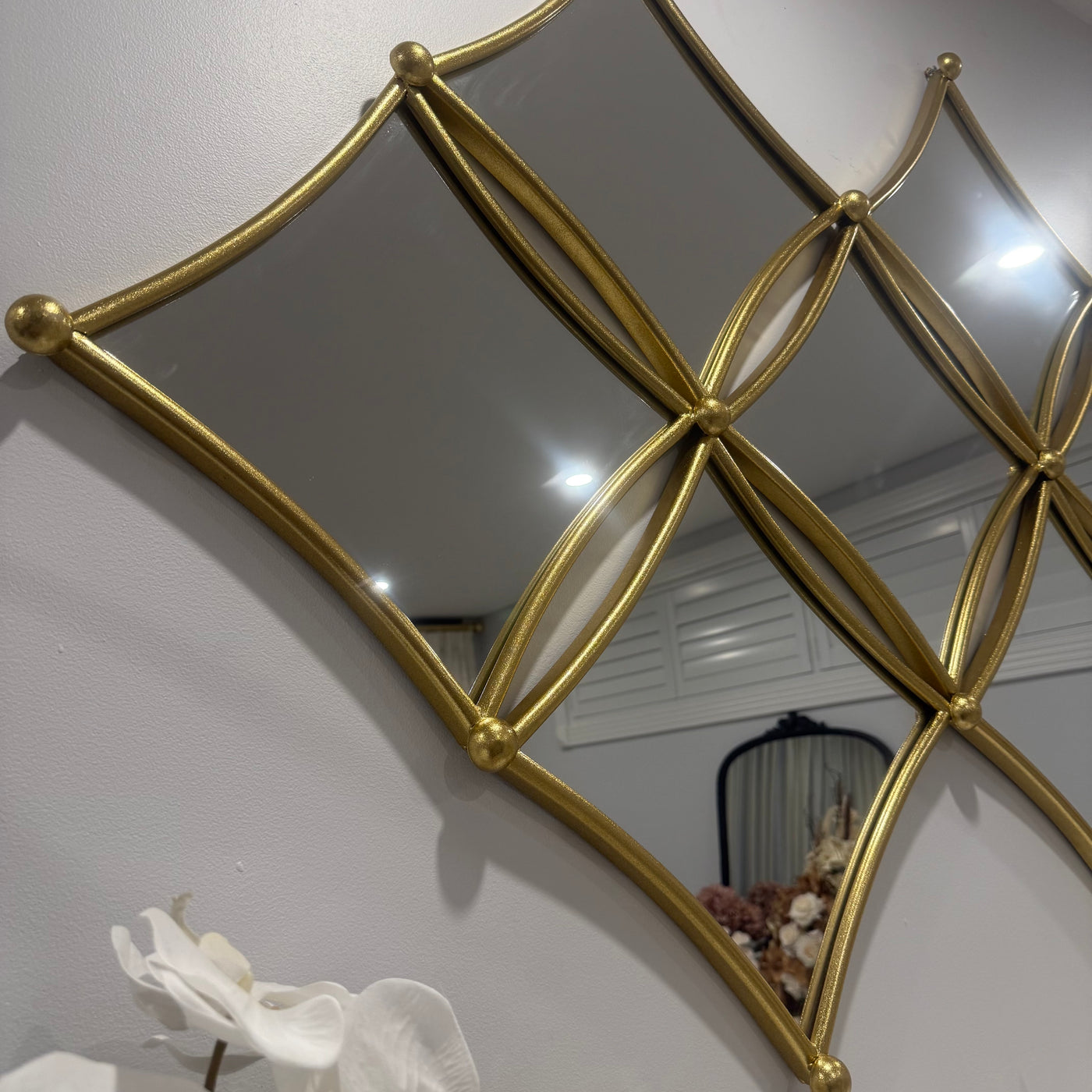 Diamond shaped wall mirror